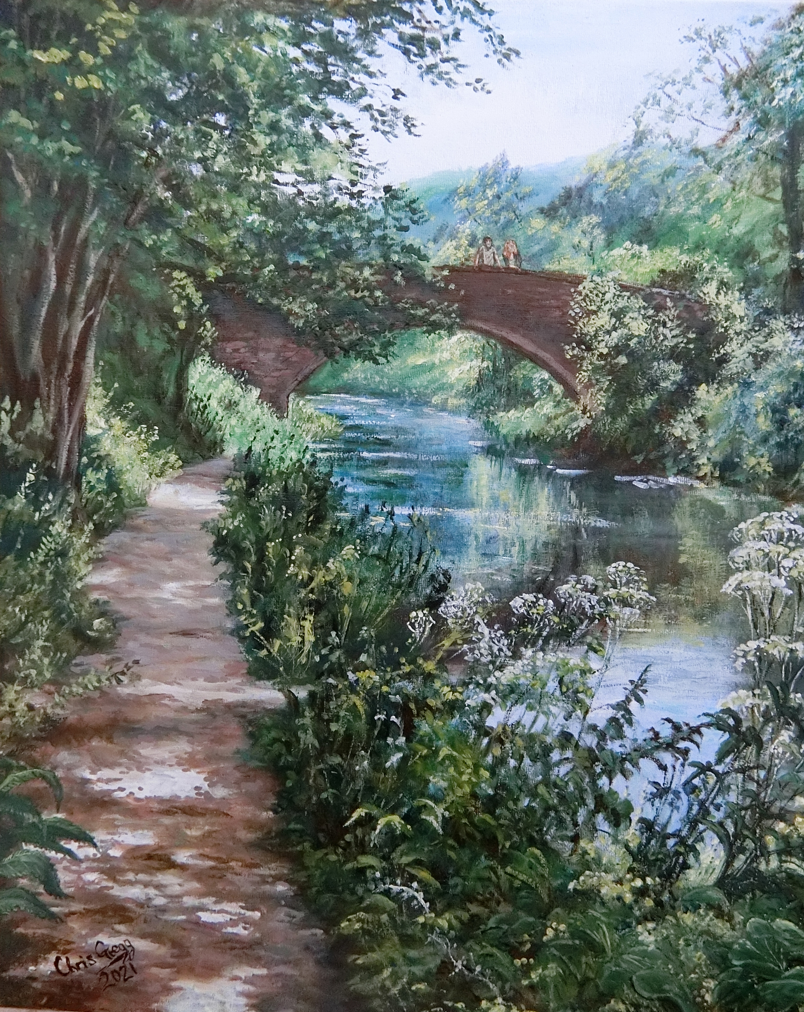 A couple pauses at the bridge to admire the scene